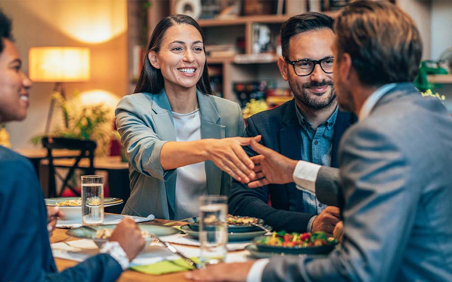 Business team having lunch together at restaurant.